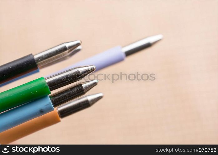 Multi colored pen on a textured background on display