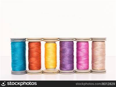 Multi-colored threads, sewing kit, a set of tailor on white background