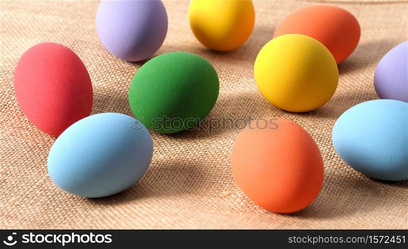 Multi-colorful of easter eggs on background in studio with close-up shot which include many colour such as yellow, green, blue, purple, red covered on eggs by art painting