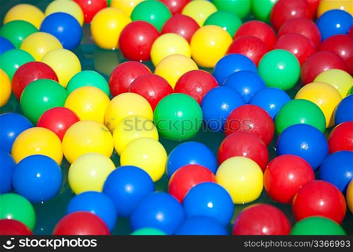 Multi-coloured balls float on water