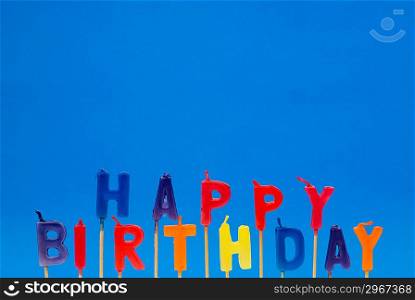 Multi coloured candles with &acute;Birthday&acute; - plenty of copyspace