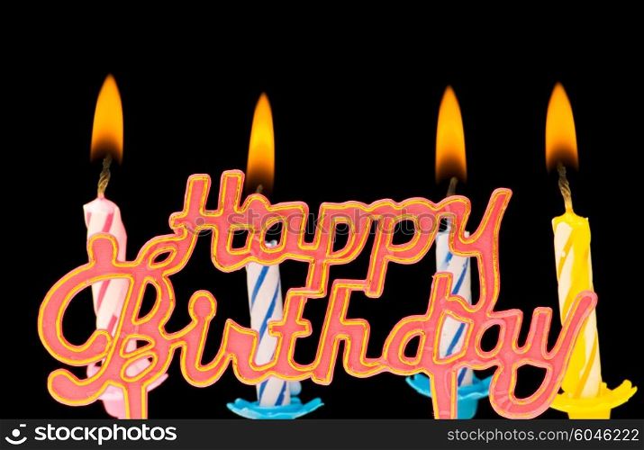 "Multi coloured candles with "Birthday" isolated on black"