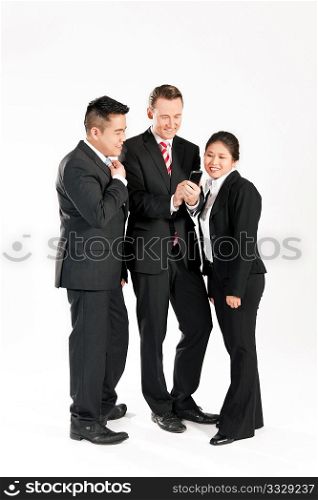 Multi-ethnic business people standing together and looking at a mobile phone
