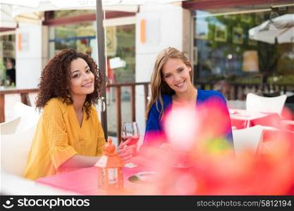 Multi ethnic friends taking and drinking in coffeeshop terrace
