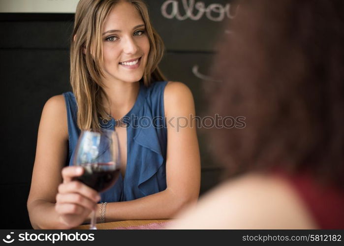 Multi ethnic friends talking and drinking in bar