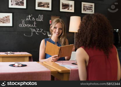 Multi ethnic friends talking and drinking in bar