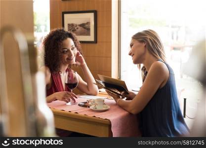 Multi ethnic friends talking and drinking in bar