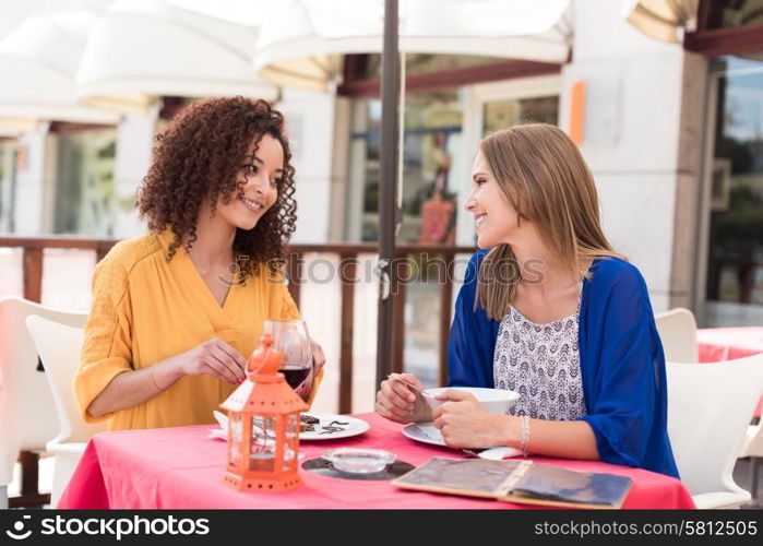 Multi-Ethnic friends talking and having fun at bar&rsquo;s balcony