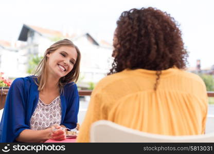 Multi-Ethnic friends talking and having fun at bar&rsquo;s balcony