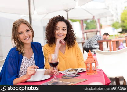 Multi-Ethnic friends talking and having fun at bar&rsquo;s balcony