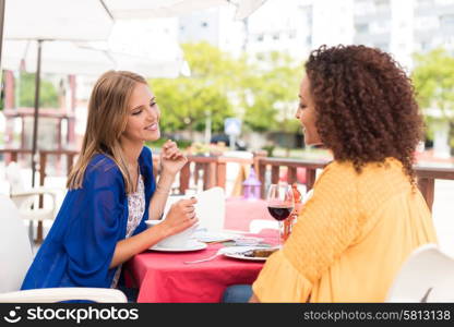 Multi-Ethnic friends talking and having fun at bar&rsquo;s balcony
