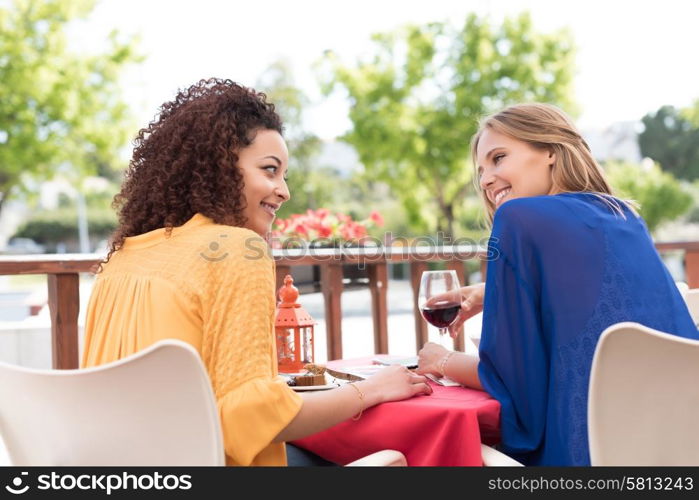 Multi-Ethnic friends talking and having fun at bar&rsquo;s balcony