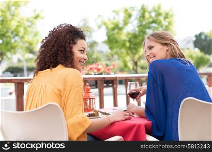 Multi-Ethnic friends talking and having fun at bar&rsquo;s balcony