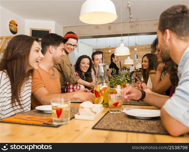 Multi-Ethnic Group of happy friends lunching and having fun at the restaurant