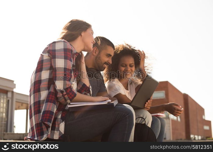 Multi-Ethnic group of students with laptop in campus - Soft sunset Light