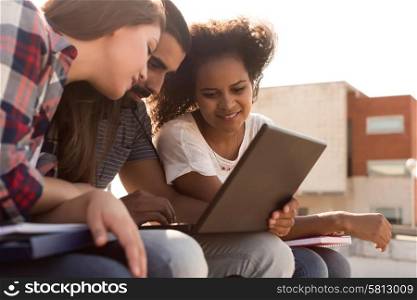 Multi-Ethnic group of students with laptop in campus - Soft sunset Light
