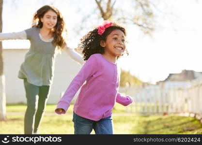 Multi ethnic kid girls playing running in park outdoor