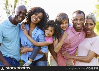 Multi Generation African American Family Standing In Garden