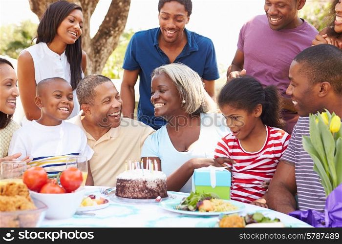 Multi Generation Family Celebrating Birthday In Garden