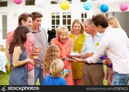 Multi Generation Family Celebrating Birthday In Garden