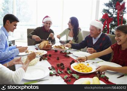 Multi Generation Family Enjoying Christmas Meal At Home