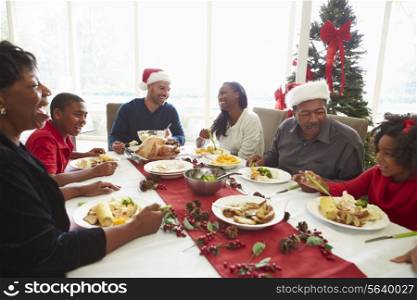 Multi Generation Family Enjoying Christmas Meal At Home