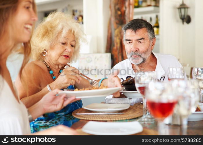 Multi Generation Family Enjoying Meal In Restaurant