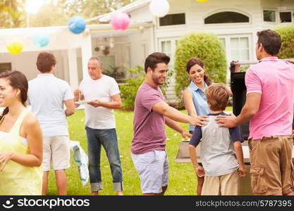 Multi Generation Family Enjoying Party In Garden Together