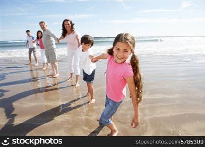 Multi Generation Family Having Fun On Beach Holiday