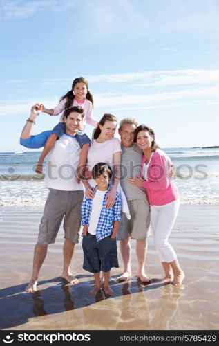 Multi Generation Family Having Fun On Beach Holiday