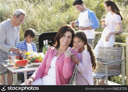 Multi Generation Family Having Outdoor Barbeque