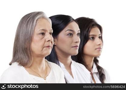 Multi-generation family over white background