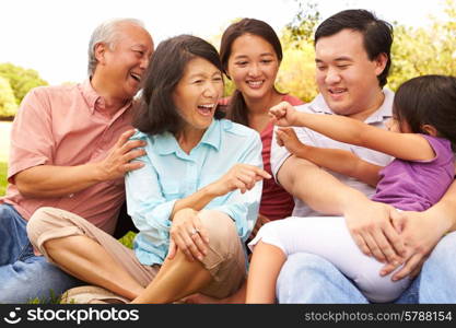 Multi Generation Family Playing Game In Park Together