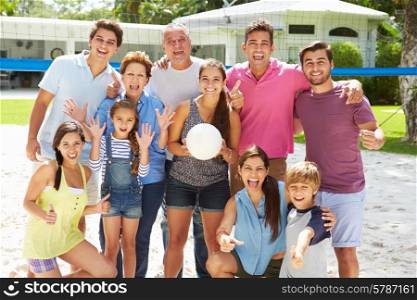 Multi Generation Family Playing Volleyball In Garden