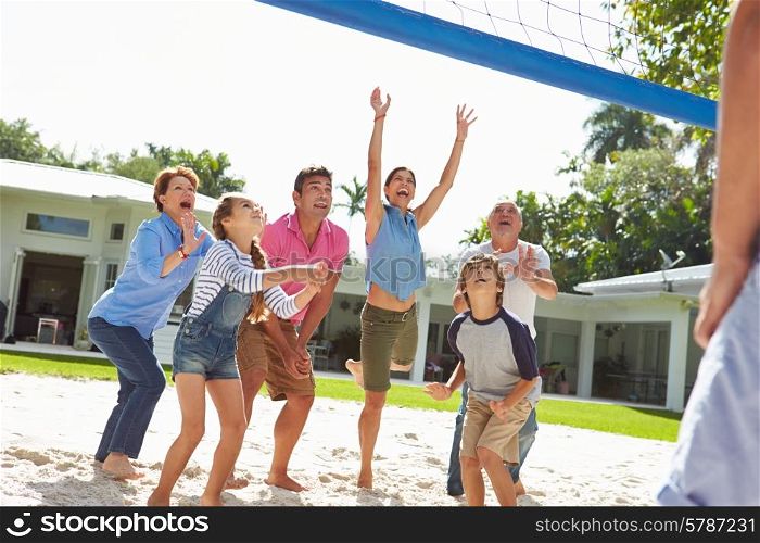 Multi Generation Family Playing Volleyball In Garden