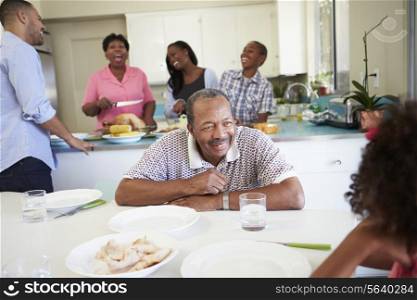 Multi-Generation Family Preparing For Meal At Home