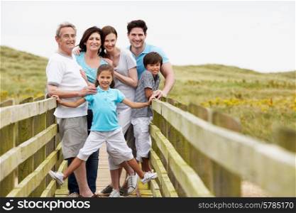 Multi Generation Family Walking Along Wooden Bridge