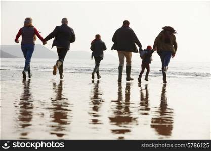 Multi Generation Family Walking On Winter Beach