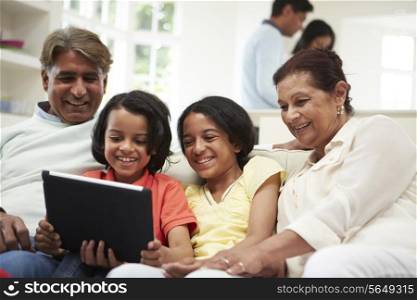 Multi-Generation Indian Family With Digital Tablet