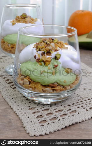 Multi-layered parfait with avocado and cream in nuts