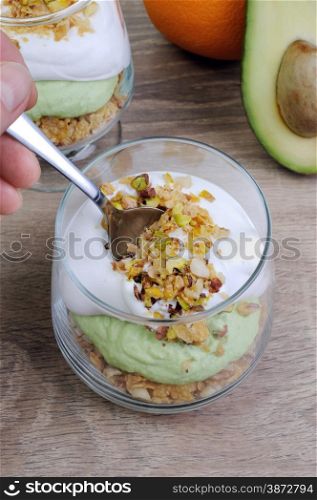 Multi-layered parfait with avocado and cream in nuts