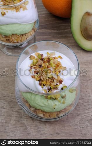 Multi-layered parfait with avocado and cream in nuts
