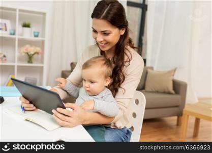 multi-tasking, education, motherhood and technology concept - happy mother student with baby and tablet pc computer learning at home. mother student with baby and tablet pc at home