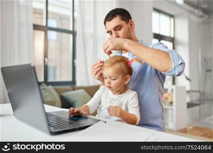 multi-tasking, freelance and fatherhood concept - working father with baby daughter and laptop computer at home office. working father with baby daughter at home office