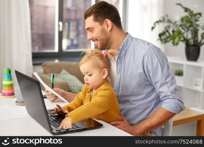 multi-tasking, freelance and fatherhood concept - working father with baby daughter and laptop computer at home office. working father with baby daughter at home office