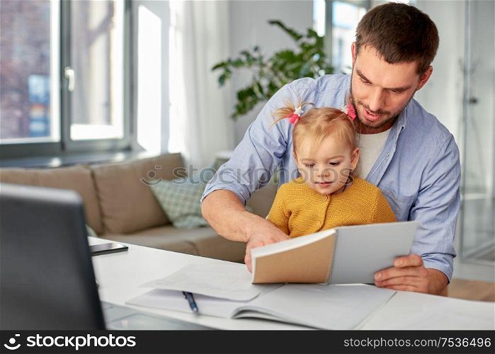 multi-tasking, freelance and fatherhood concept - working father with baby daughter and notebook at home office. working father with baby daughter at home office