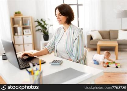 multi-tasking, freelance and motherhood concept - mother working at laptop computer and baby boy at home office. mother working at laptop and baby boy at home