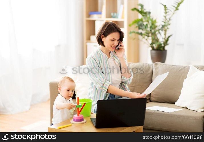 multi-tasking, freelance and motherhood concept - working mother with papers calling on smartphone and baby son playing with toys at home. working mother with baby calling on smartphone