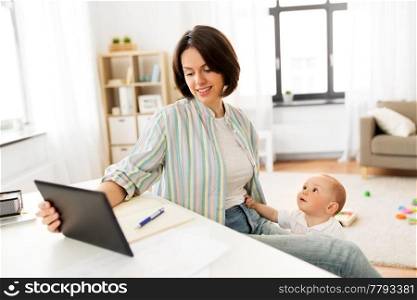 multi-tasking, freelance and motherhood concept - working mother with tablet pc computer and baby boy at home. working mother with tablet pc and baby at home