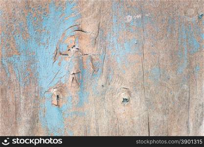 Multicolored background: wooden surface with blue paint flaking and cracking texture